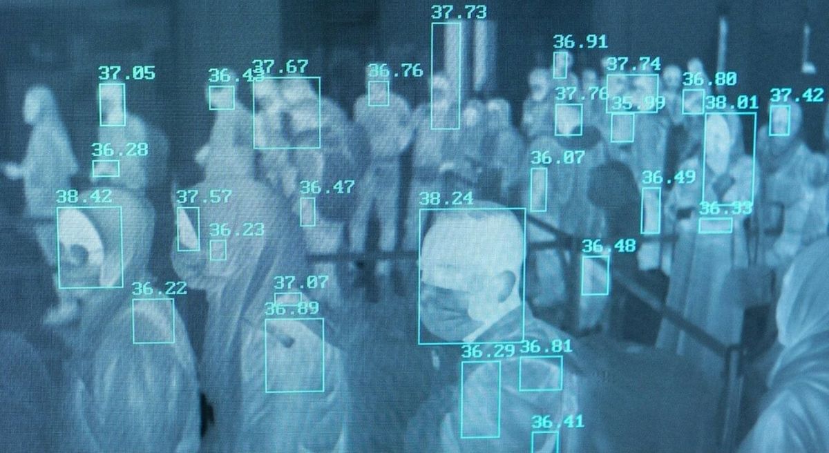 Thermal camera view of a crowd, each person boxed and labelled with a temperature reading